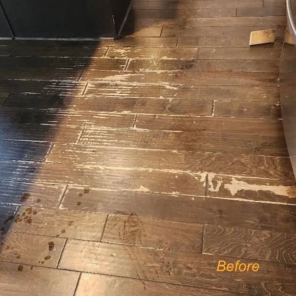 Severely damaged dark hardwood — peeling and scratched before refinishing
